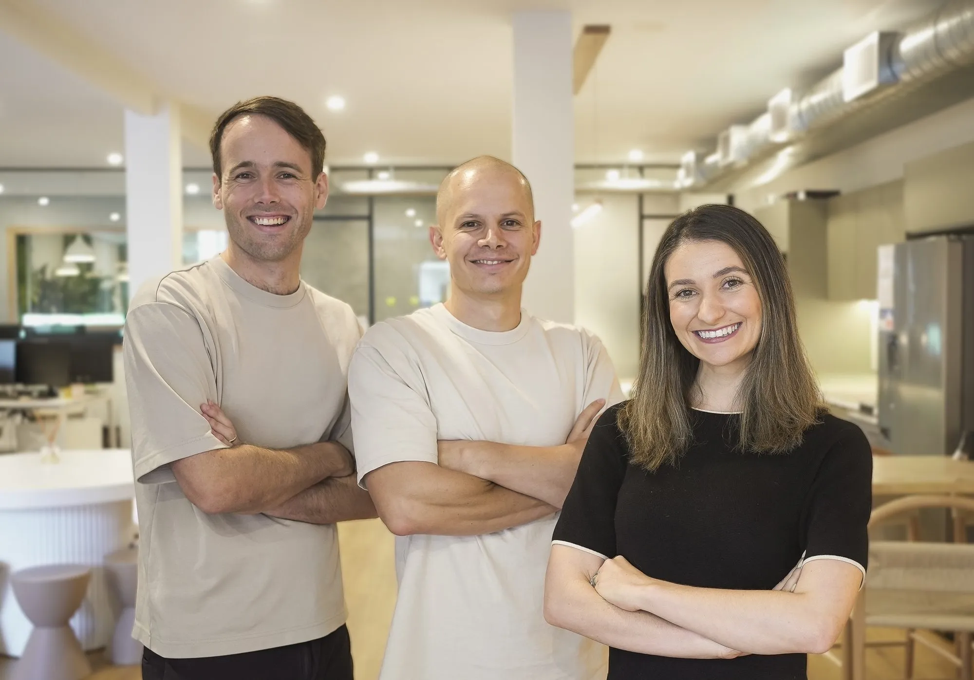 Three members of the Webhaus team standing with arms crossed